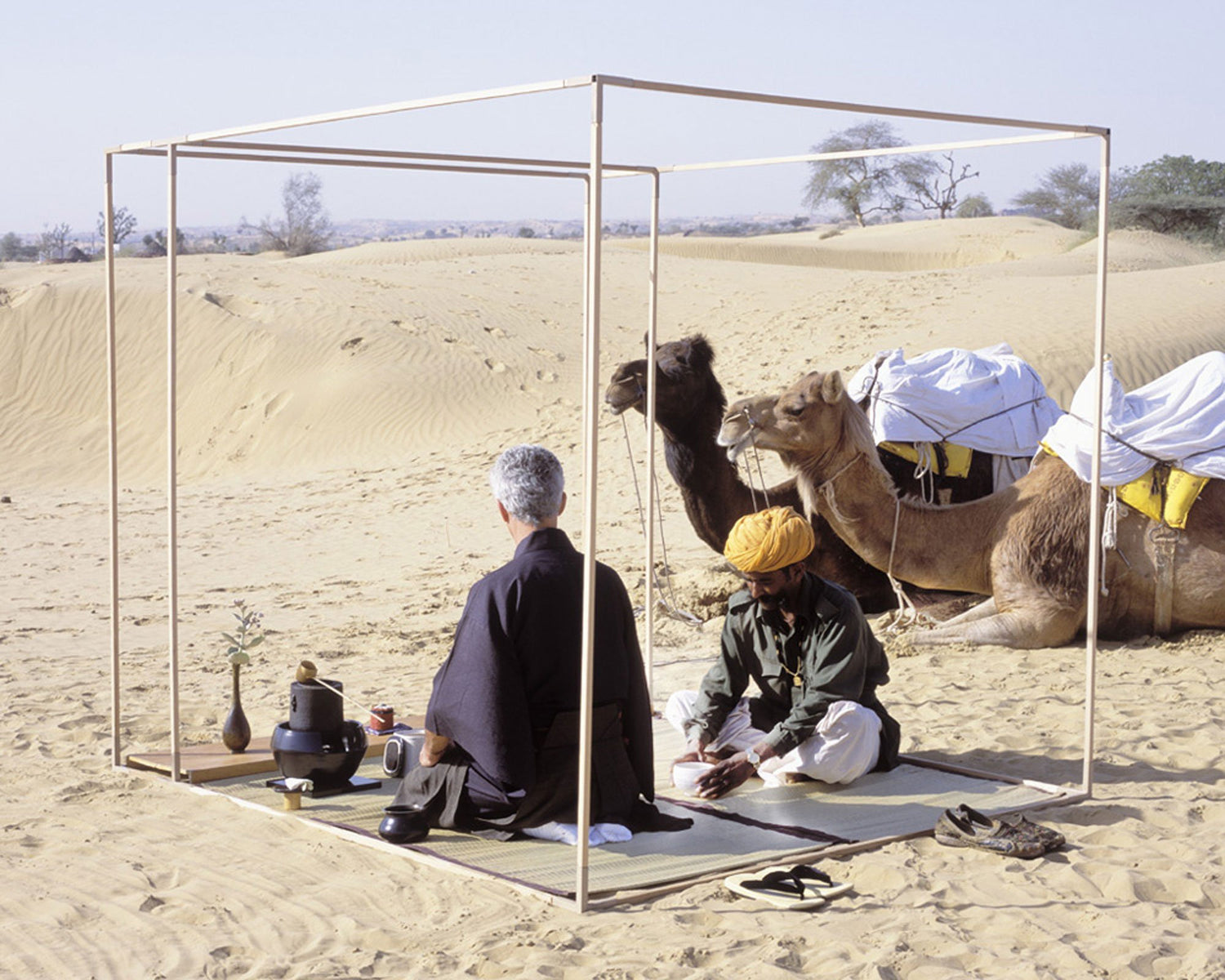 img src=”image.jpg” alt=”Pierre having tea in the desert” /